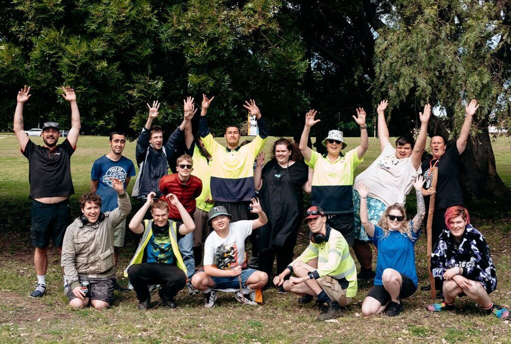 Group photo. Outside. Hands in air.