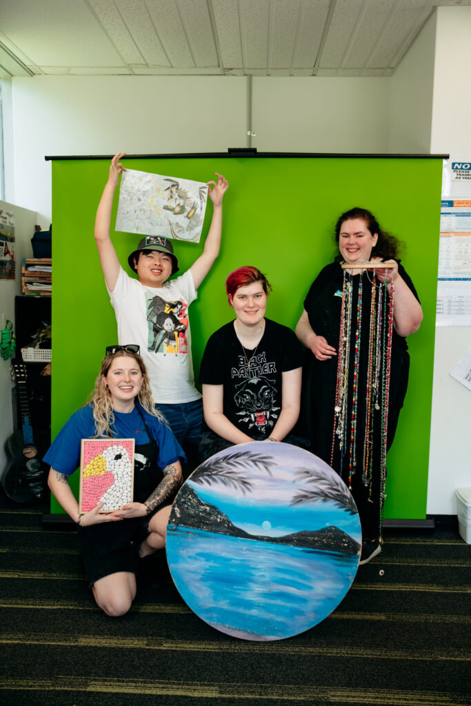 Group shot. Support worker and three participants with Art. We Belong Program